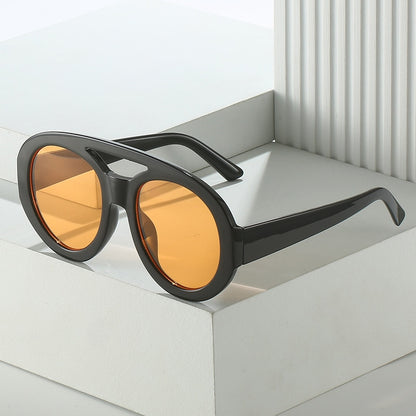 Playpark Arthur Sunglasses features on display with our transparent orange lenses and dark black frames.