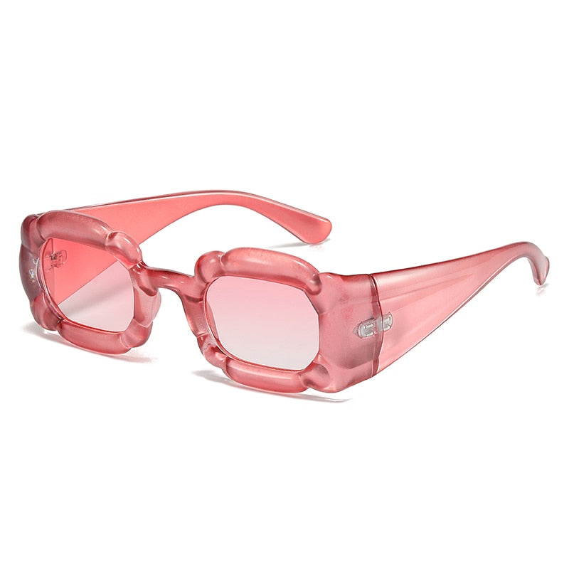 Playpark Cloud Sunglasses feature wavy frames made from recycled materials with 400 UV protection lenses. Featured colour rose.