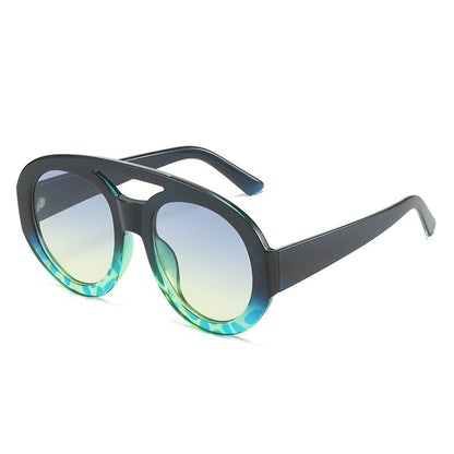 Playpark Arthur Sunglasses features a half navy and blue ombre frame with a mix of solid and transparent colours. Clear lenses with 400UV protection and made from 100% recycled materials. 